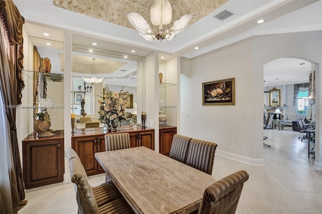 15595 Chandelle Pl, Wellington, FL 33414 - dining space with a chandelier, arched walkways, a raised ceiling, light tile patterned floors, and recessed lighting