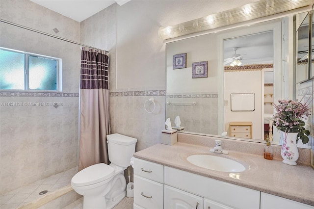 15595 Chandelle Pl, Wellington, FL 33414 - ensuite bathroom with ceiling fan, tiled shower, vanity, tile patterned flooring, and tile walls