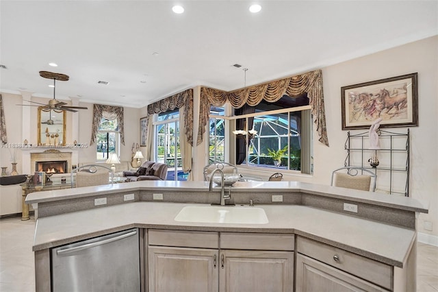 15595 Chandelle Pl, Wellington, FL 33414 - kitchen featuring stainless steel dishwasher, open floor plan, a lit fireplace, recessed lighting, and light countertops