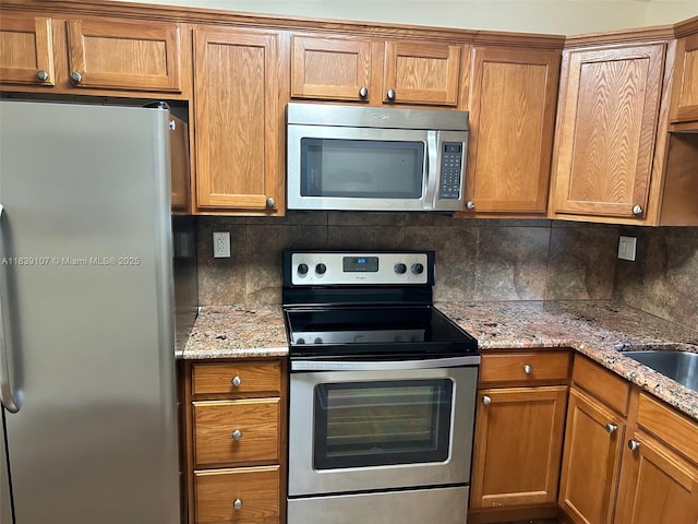 371 S Hollybrook Dr Unit 308, Pembroke Pines, FL 33025 - kitchen with stainless steel appliances, decorative backsplash, and brown cabinets