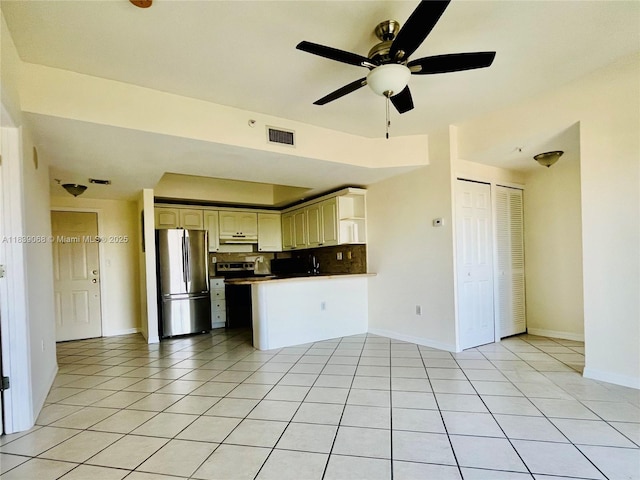 3500 Coral Way Unit 913, Miami, FL 33145 - kitchen featuring stainless steel appliances, ceiling fan, under cabinet range hood, a peninsula, and light tile patterned flooring