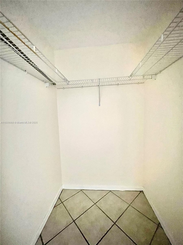3500 Coral Way Unit 913, Miami, FL 33145 - walk in closet featuring tile patterned floors