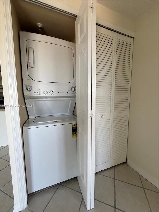3500 Coral Way Unit 913, Miami, FL 33145 - laundry room with stacked washing machine and dryer and light tile patterned floors