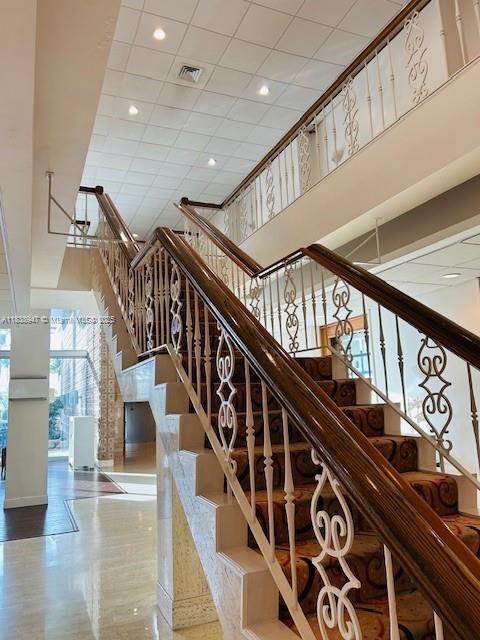 2899 Collins Ave Unit 1504, Miami Beach, FL 33140 - stairs featuring a high ceiling and recessed lighting