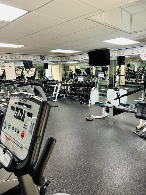 2899 Collins Ave Unit 1504, Miami Beach, FL 33140 - gym featuring a paneled ceiling