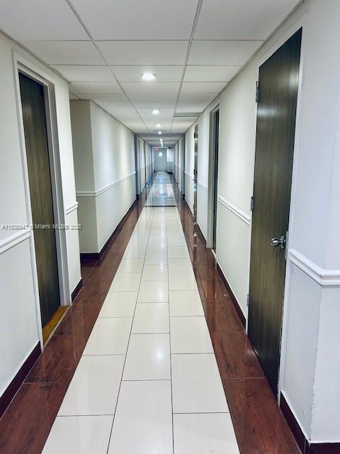 2899 Collins Ave Unit 1504, Miami Beach, FL 33140 - corridor with a drop ceiling and dark tile patterned floors