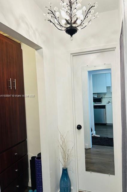 2899 Collins Ave Unit 1504, Miami Beach, FL 33140 - corridor featuring a chandelier
