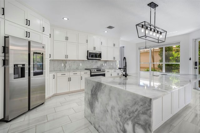 5050 Greenwich Preserve Ct, Boynton Beach, FL 33436 - kitchen with stainless steel appliances, tasteful backsplash, white cabinetry, light stone countertops, and recessed lighting