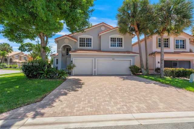 5050 Greenwich Preserve Ct, Boynton Beach, FL 33436 - mediterranean / spanish-style home featuring decorative driveway, an attached garage, stucco siding, and a front lawn