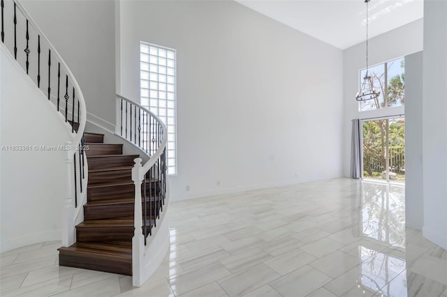 5050 Greenwich Preserve Ct, Boynton Beach, FL 33436 - stairway with a towering ceiling and a chandelier