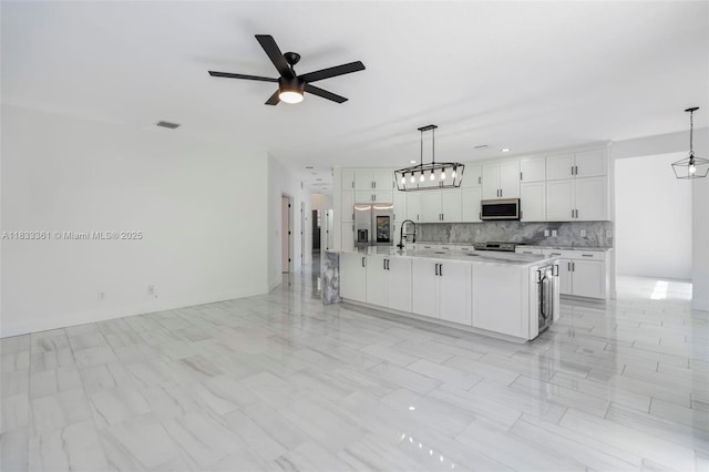 5050 Greenwich Preserve Ct, Boynton Beach, FL 33436 - kitchen featuring appliances with stainless steel finishes, light countertops, ceiling fan, decorative backsplash, and white cabinets