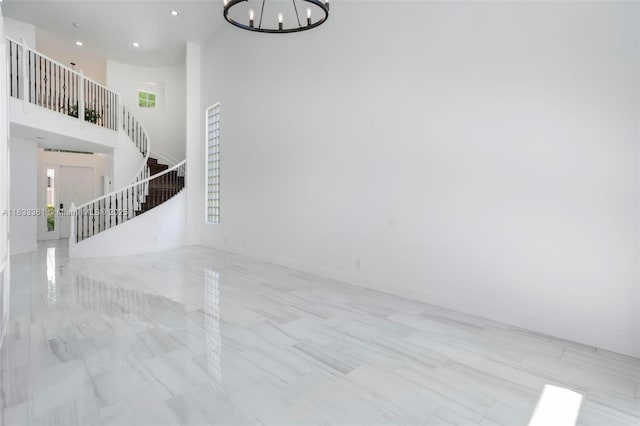 5050 Greenwich Preserve Ct, Boynton Beach, FL 33436 - unfurnished living room with stairway, a chandelier, recessed lighting, and a towering ceiling