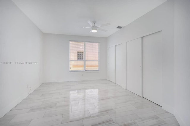5050 Greenwich Preserve Ct, Boynton Beach, FL 33436 - unfurnished bedroom featuring two closets and a ceiling fan