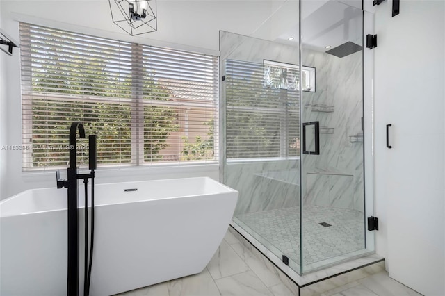 5050 Greenwich Preserve Ct, Boynton Beach, FL 33436 - full bathroom featuring marble look tile flooring, healthy amount of natural light, a freestanding bath, and a marble finish shower