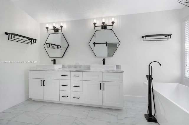 5050 Greenwich Preserve Ct, Boynton Beach, FL 33436 - full bathroom featuring marble finish floors, double vanity, a freestanding tub, and a chandelier