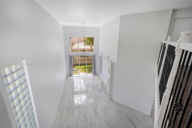 5050 Greenwich Preserve Ct, Boynton Beach, FL 33436 - hallway featuring a chandelier, a towering ceiling, recessed lighting, and light wood-style floors