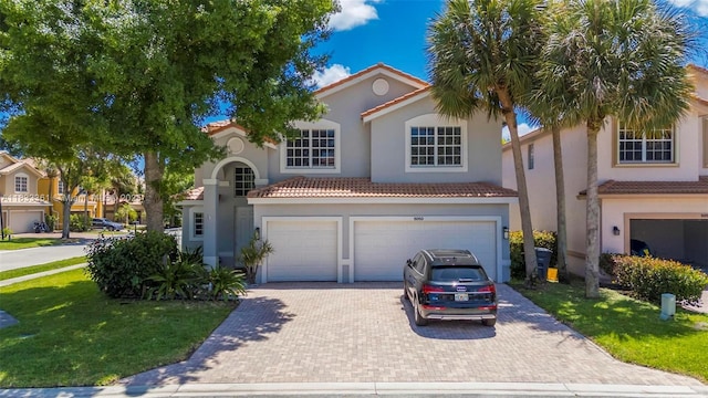 5050 Greenwich Preserve Ct, Boynton Beach, FL 33436 - mediterranean / spanish-style house featuring an attached garage, stucco siding, driveway, and a front lawn