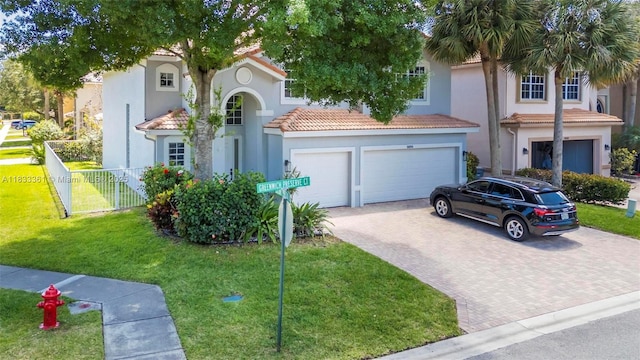 5050 Greenwich Preserve Ct, Boynton Beach, FL 33436 - mediterranean / spanish home featuring an attached garage, decorative driveway, stucco siding, and a tiled roof