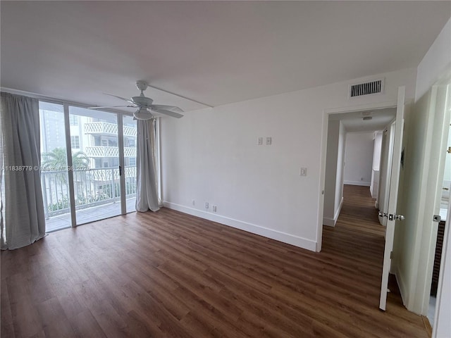 1440 Brickell Bay Dr Unit 307, Miami, FL 33131 - spare room featuring dark wood-style flooring, floor to ceiling windows, and ceiling fan