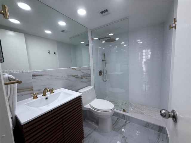 1440 Brickell Bay Dr Unit 307, Miami, FL 33131 - bathroom with marble finish floors, vanity, a walk in shower, recessed lighting, and tile walls