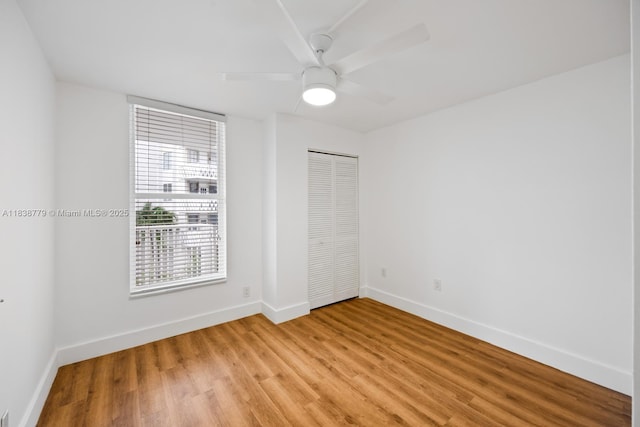 1440 Brickell Bay Dr Unit 307, Miami, FL 33131 - unfurnished bedroom featuring light wood-style floors, a closet, and ceiling fan
