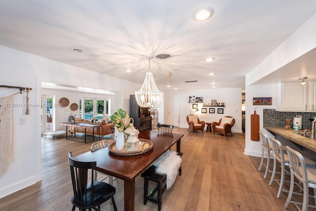 6957 SW 148th Ter, Palmetto Bay, FL 33158 - dining space featuring wood finished floors, recessed lighting, and a chandelier