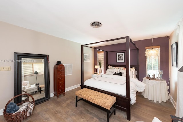 6957 SW 148th Ter, Palmetto Bay, FL 33158 - bedroom with wood finished floors, multiple windows, and a chandelier