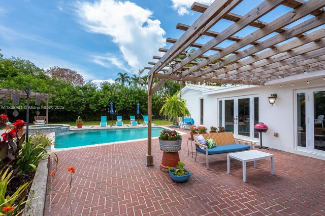 6957 SW 148th Ter, Palmetto Bay, FL 33158 - view of swimming pool with french doors, a pergola, a pool with connected hot tub, and a patio area