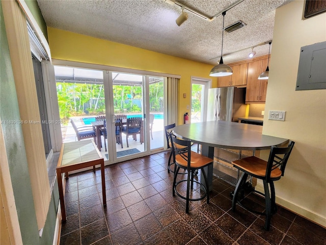 2451 SW 16th St, Fort Lauderdale, FL 33312 - dining area featuring rail lighting, a textured ceiling, and electric panel