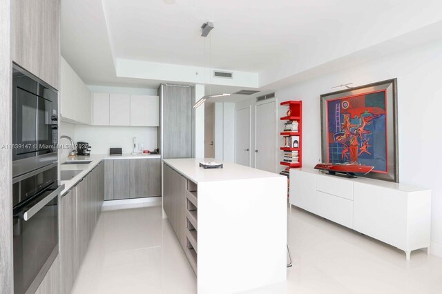 2900 NE 7th Ave Unit 404, Miami, FL 33137 - kitchen with modern cabinets, black appliances, and a kitchen island