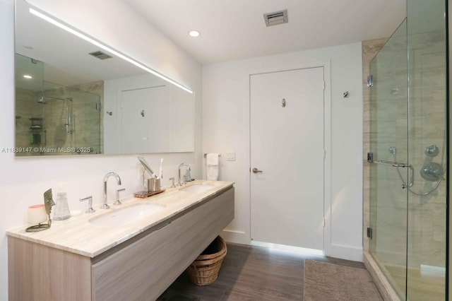 2900 NE 7th Ave Unit 404, Miami, FL 33137 - bathroom with wood finished floors, a stall shower, double vanity, and recessed lighting