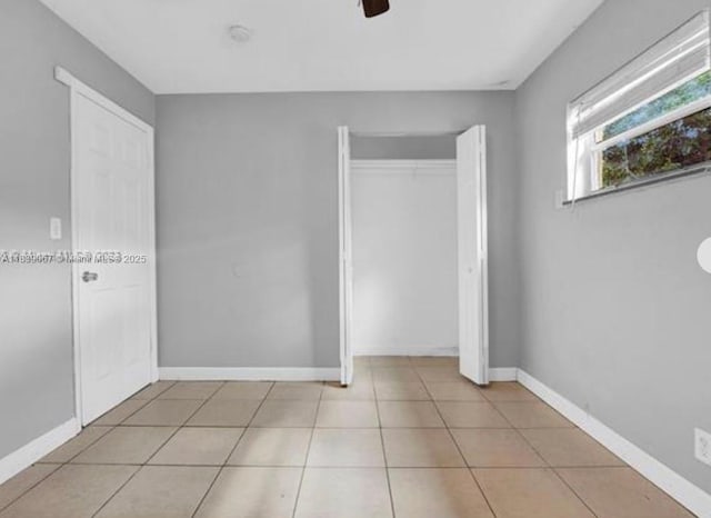 130 NE 21st Ct, Pompano Beach, FL 33060 - unfurnished bedroom featuring tile patterned floors, ceiling fan, and a closet