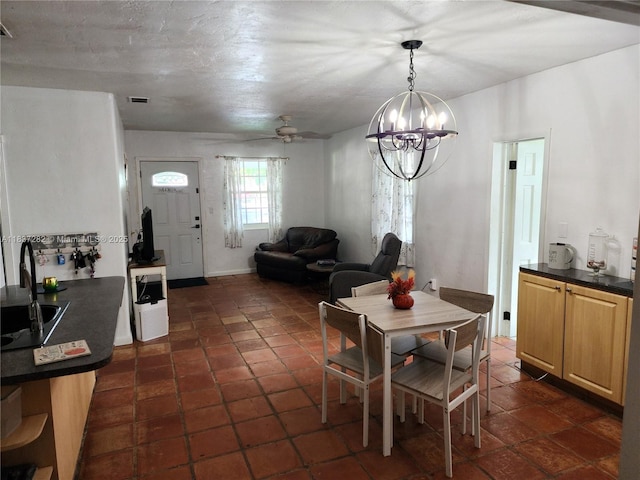 3521 E 8th Ave, Hialeah, FL 33013 - dining space featuring a chandelier and ceiling fan