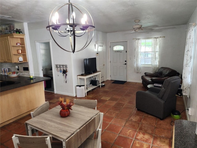 3521 E 8th Ave, Hialeah, FL 33013 - living room featuring a chandelier, ceiling fan, and dark tile patterned floors