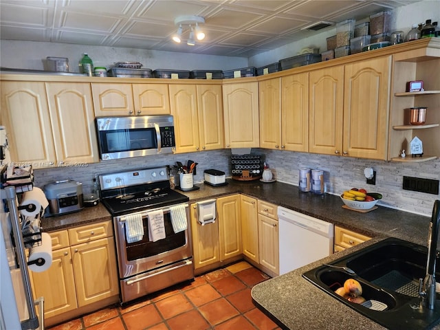 3521 E 8th Ave, Hialeah, FL 33013 - kitchen with stainless steel appliances, backsplash, light brown cabinetry, and light tile patterned floors