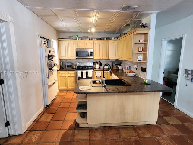 3521 E 8th Ave, Hialeah, FL 33013 - kitchen with appliances with stainless steel finishes, open shelves, dark countertops, and light brown cabinets