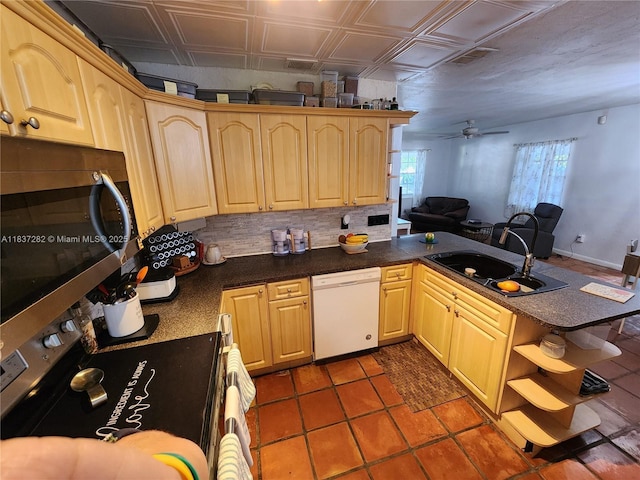 3521 E 8th Ave, Hialeah, FL 33013 - kitchen featuring stainless steel appliances, a peninsula, light brown cabinetry, open floor plan, and ceiling fan