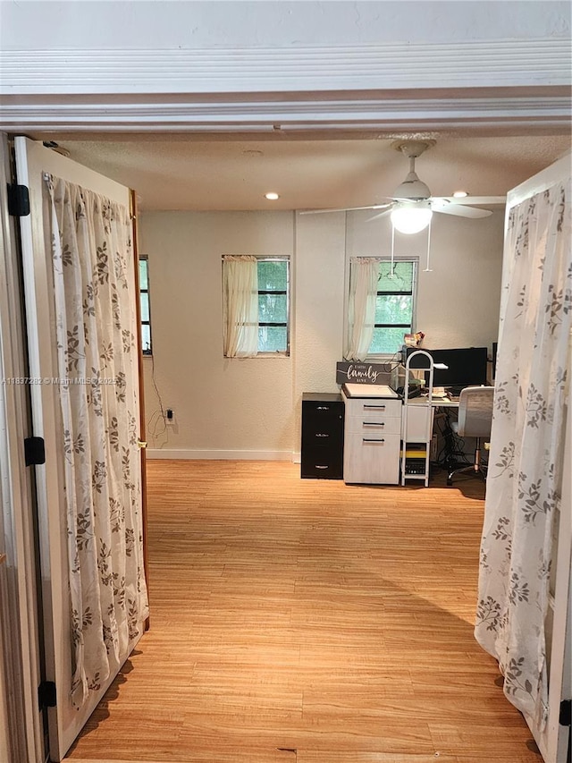 3521 E 8th Ave, Hialeah, FL 33013 - hallway featuring light wood finished floors and a desk