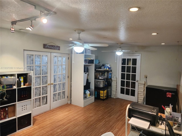 3521 E 8th Ave, Hialeah, FL 33013 - living area featuring a textured ceiling, ceiling fan, wood finished floors, french doors, and track lighting