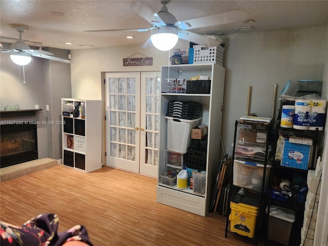 3521 E 8th Ave, Hialeah, FL 33013 - living room featuring ceiling fan, a brick fireplace, wood finished floors, french doors, and recessed lighting