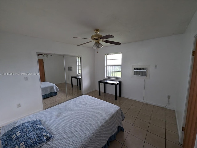 3521 E 8th Ave, Hialeah, FL 33013 - bedroom featuring light tile patterned flooring, a wall mounted air conditioner, a closet, and a ceiling fan
