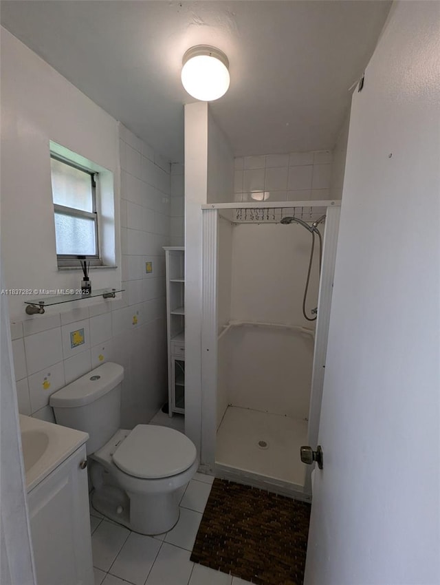3521 E 8th Ave, Hialeah, FL 33013 - bathroom with a shower stall, vanity, tile walls, and tile patterned floors