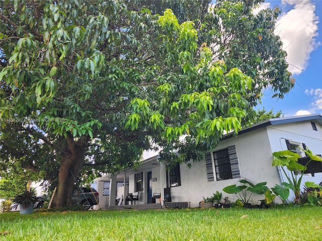 3521 E 8th Ave, Hialeah, FL 33013 - view of side of home featuring stucco siding and a yard