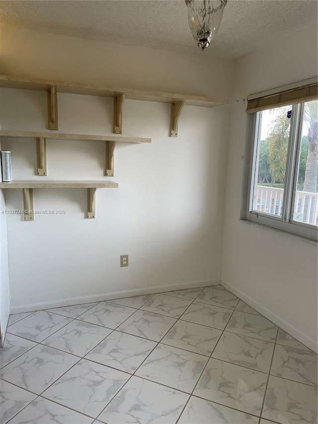 7152 S Devon Dr Unit 304, Tamarac, FL 33321 - empty room featuring light marble finish floors and a textured ceiling
