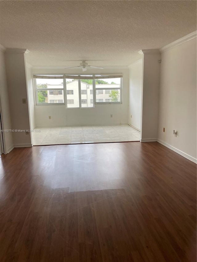 7152 S Devon Dr Unit 304, Tamarac, FL 33321 - unfurnished room featuring crown molding, healthy amount of natural light, a textured ceiling, ceiling fan, and wood finished floors