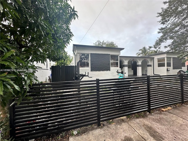 101 NW 68th Ter, Miami, FL 33150 - view of front of property with stucco siding and a fenced front yard