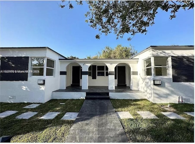 101 NW 68th Ter, Miami, FL 33150 - view of front of house featuring a porch and stucco siding