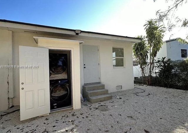 101 NW 68th Ter, Miami, FL 33150 - view of exterior entry with stacked washing machine and dryer and stucco siding