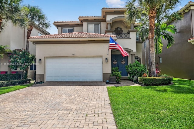 1086 Grove Park Cir, Boynton Beach, FL 33436 - mediterranean / spanish-style home with a garage, stucco siding, decorative driveway, a front yard, and a tile roof