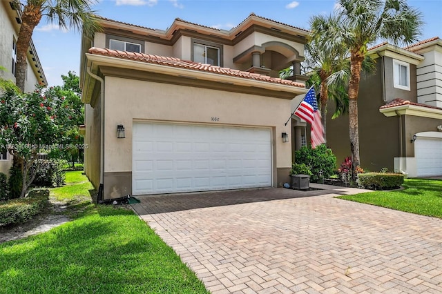 1086 Grove Park Cir, Boynton Beach, FL 33436 - mediterranean / spanish-style home featuring decorative driveway, stucco siding, an attached garage, and a front yard
